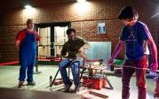 A group of people doing glassblowing.